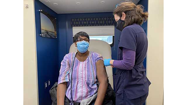 MedStar Health administers coronavirus vaccine to community members inside mobile center.