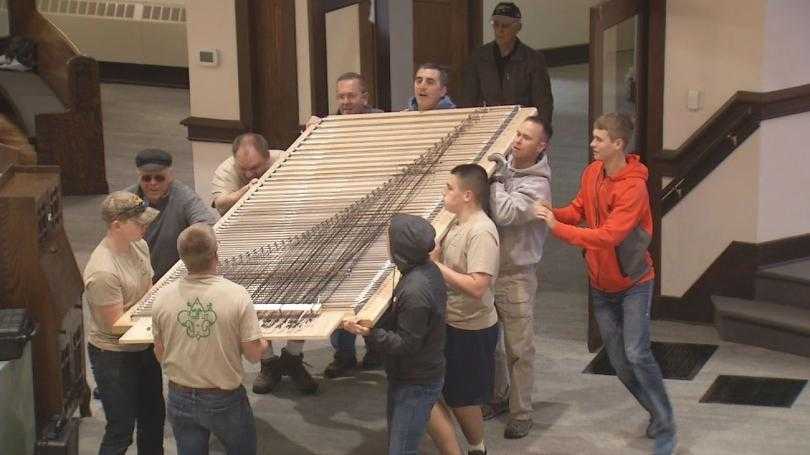 Volunteers help set up new pipe organ after tornado damages church