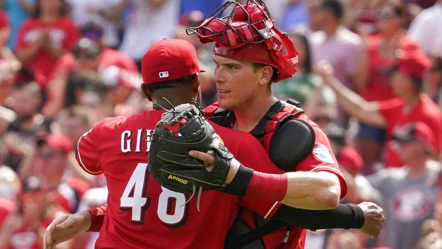 Cincinnati Reds relief pitcher Mychal Givens (48) celebrates with catcher Tyler Stephenson after defeating the Pittsburgh Pirates in Cincinnati, Sunday, Aug. 8, 2021. (AP Photo/Jeff Dean)