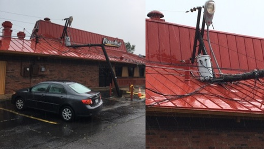Photos showing a power pole that fell onto a Pizza Hut in Van Buren