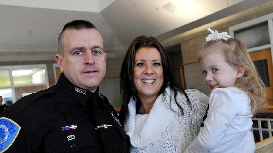 In this December 2012 photo. officer Michael Chesna is joined by his wife Cindy and daughter, Olivia, 3, after being sworn in as a Weymouth Police Officer.