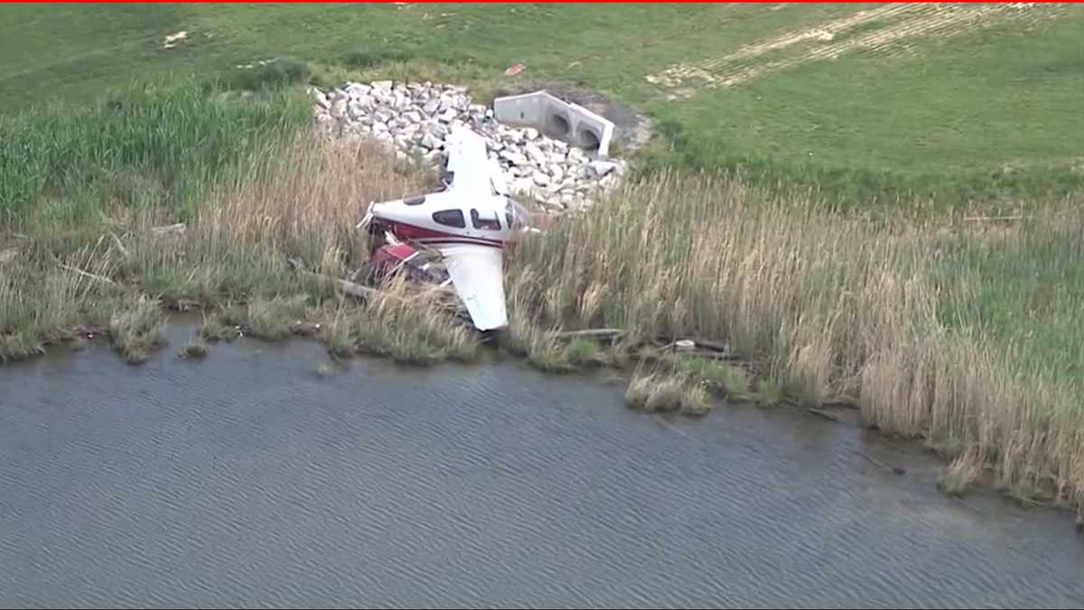 Small plane off runway, on shoreline near Bay Bridge Airport