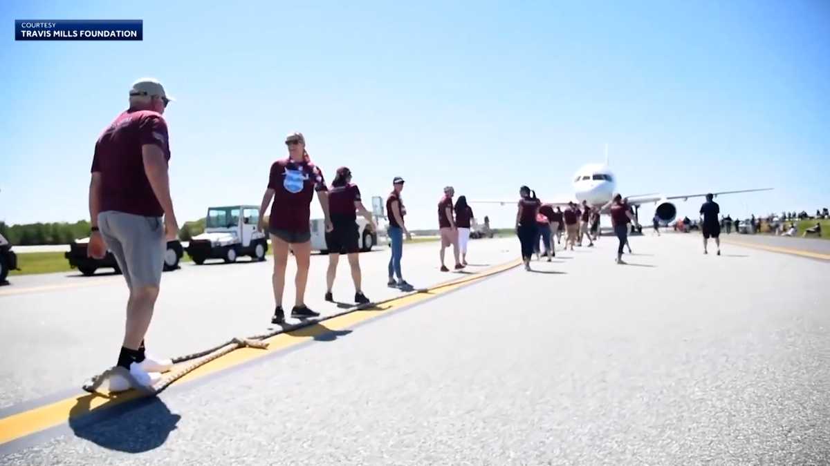 Travis Mills Plane Pull 2024 India - Aleta Loreen