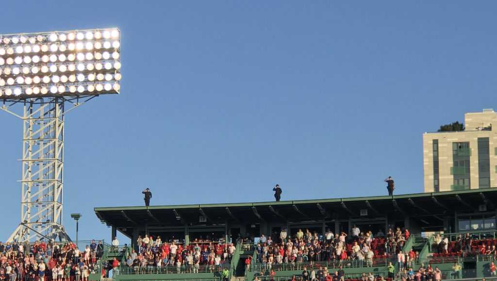 Fan struggles to put on poncho at Fenway Park 