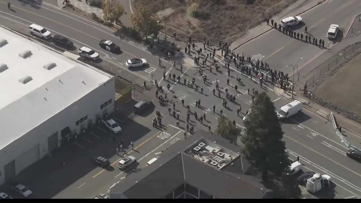 Protesters gather as federal immigration agents arrive at Coast Guard Island