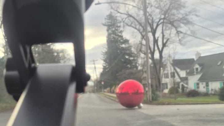 Gusty winds ship large inflatable decoration rolling by means of neighborhood