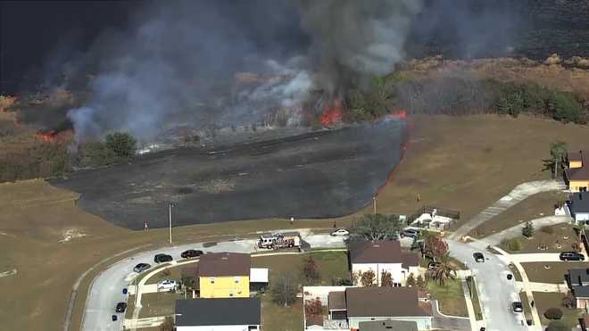 1.5-acre brush fire burns near homes in Orange County subdivision
