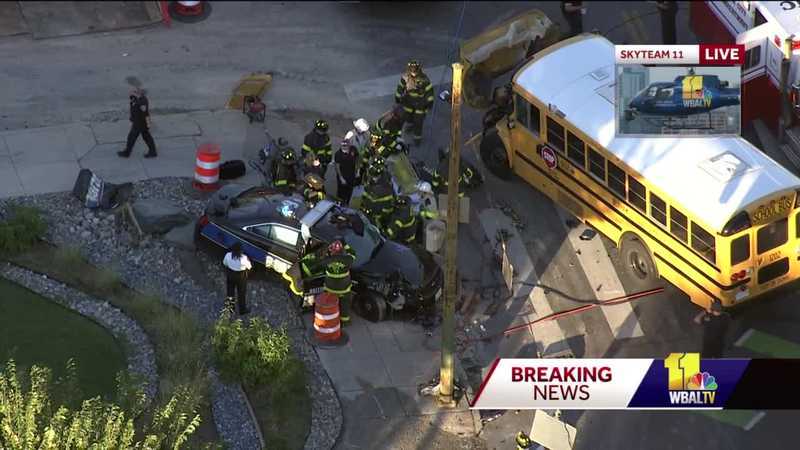 City police officer injured after vehicle crashes into school bus