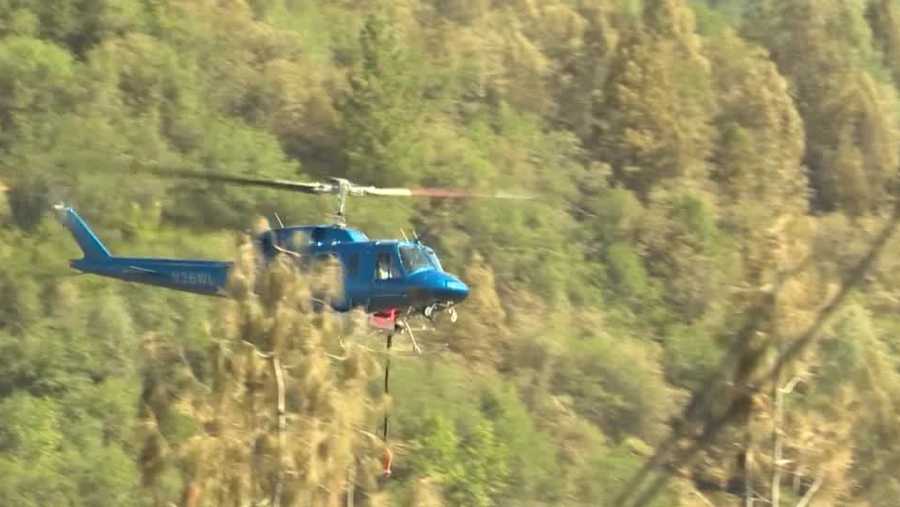helicopter assists in subduing bridge fire in placer county