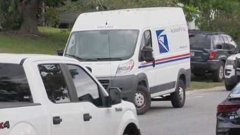 Officials said a postal worker was robbed by a gunman in Orange County