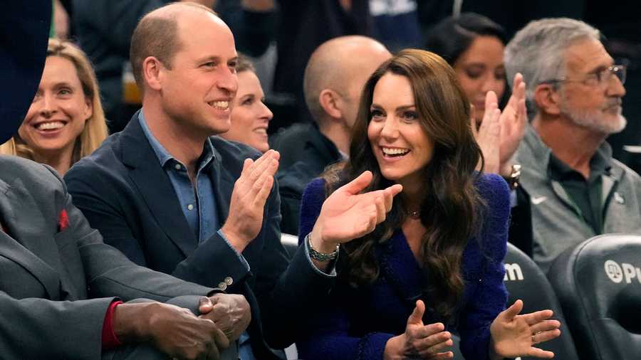 Britain's Prince William and Kate, Princess of Wales, right, laugh during the second half of an NBA basketball game between the Boston Celtics and the Miami Heat, Wednesday, Nov. 30, 2022, in Boston.