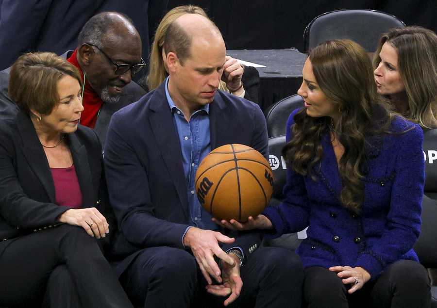 Massachusetts Gov.-elect Maura Healey looks on as Britain's Prince William is handed a basketball by Kate, Princess of Wales, as they attend an NBA basketball game between the Boston Celtics and the Miami Heat on Wednesday, Nov. 30, 2022, in Boston. (Brian Snyder/Pool Photo via AP)