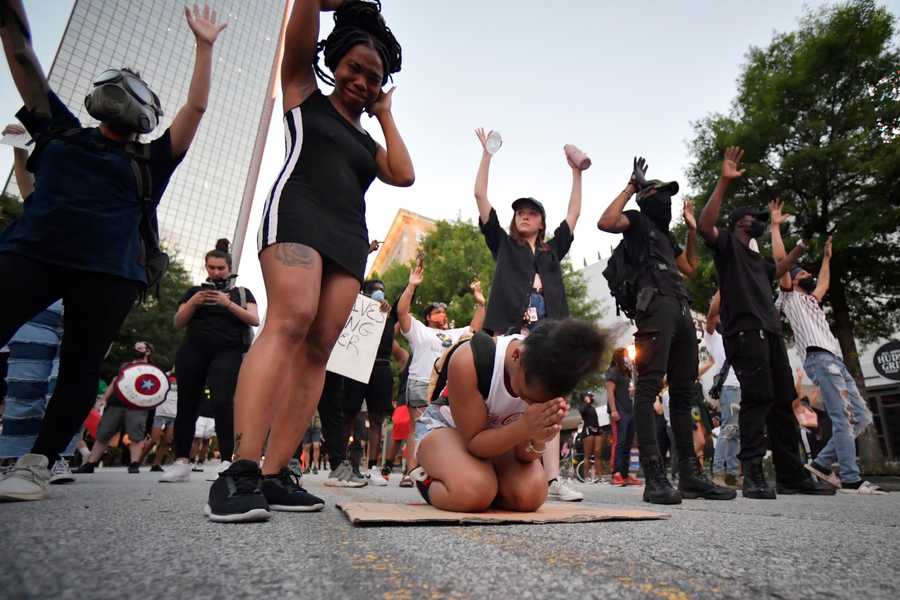 Demonstrators pray during a march, Sunday, May 31, 2020, in Atlanta. Protests continued following the death of George Floyd, who died after being restrained by Minneapolis police officers on May 25. Demonstrators pray during a march, Sunday, May 31, 2020, in Atlanta. Protests continued following the death of George Floyd, who died after being restrained by Minneapolis police officers on May 25.