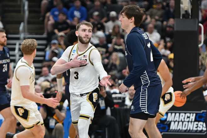 Purdue's Braden Smith (3) celebrates after making a 3-point basket as Queens University's Carson Schwieger, right, watches during the second half in the first round of the NCAA college basketball tournament, Friday, March 20, 2026, in St. Louis.