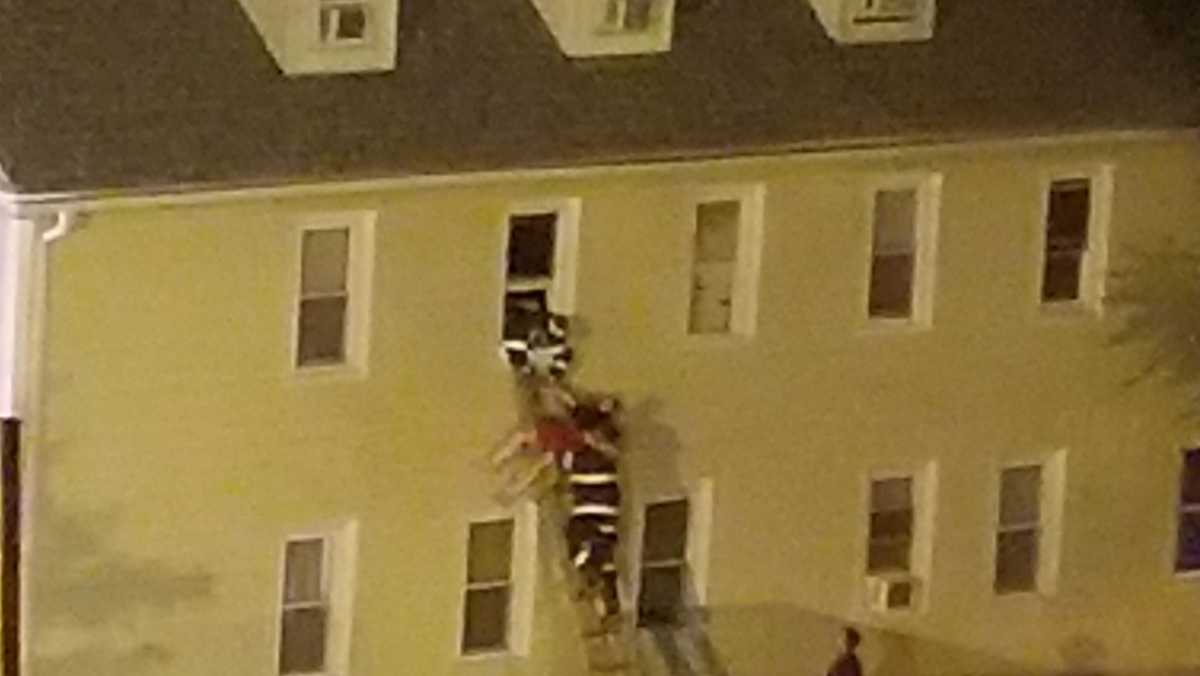 Resident jumps from burning building, firefighters rescue several others