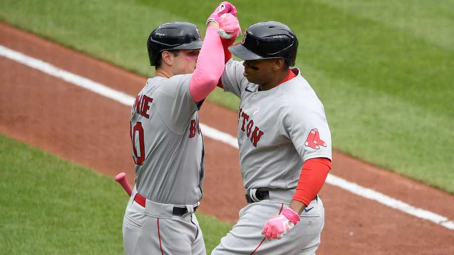 Boston Red Sox's Hunter Renfroe, left, comes in to field the