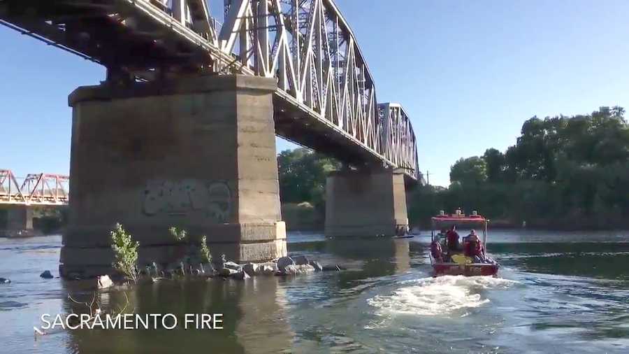 Crews recover a man’s body from the American River Sunday, July 2, 2017, after he fell off a railroad bridge crossing.
