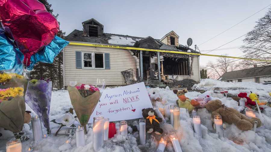 
                                     A makeshift memorial was set up in front of the burned out shell of a home which is all that is left of 900 Mann Avenue Monday March 12, 2018 after two adults and one child lost their lives in a multi-alarm fire which occurred early Sunday morning  in Rensselaer, N.Y. (Skip Dickstein/Times Union) 
                                