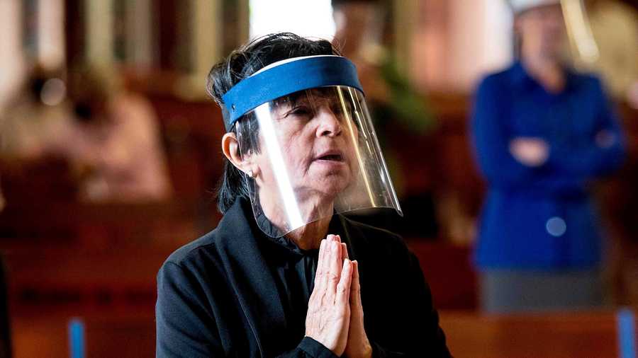 
                                     A woman wearing a face shield prays at the Basilica de los Angeles in Cartago, Costa Rica, June 28, 2020, amid the new coronavirus pandemic. - The third phase of measures against the spread of COVID-19 began Sunday in Costa Rica, allowing assistance to churches with a minimum distance of 1.8 meters between each person and with a maximum of 75 people, all with masks. (Photo by Ezequiel BECERRA / AFP) (Photo by EZEQUIEL BECERRA/AFP via Getty Images) 
                                