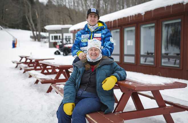 RICHMOND - FEBRUARY 18: Olympian skier Ryan Cochran-Siegle sits for a portrait with his mother Barbara Ann Cochran at his family&amp;apos;s ski lodge in Richmond, VT on Feb. 18, 2021. The bibs hanging around the lodge represent the Cochran family&amp;apos;s many ski racers. His mother, Barbara Ann Cochran is a former World Cup alpine ski racer and Olympic gold medalist. After a crash in January in the downhill race at Kitzbuehel, Cochran-Siegle suffered a broken neck and will be out for the rest of the season. (Photo by Erin Clark/The Boston Globe via Getty Images)