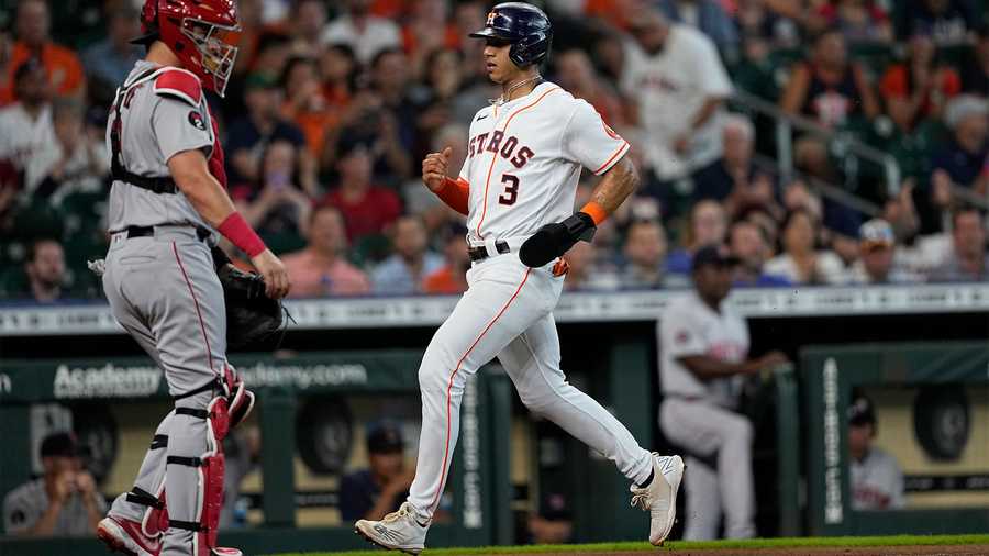 Houston Astros' Jeremy Pena (3) scores as Boston Red Sox catcher Reese McGuire stands at home plate during the first inning of a baseball game Wednesday, Aug. 3, 2022, in Houston.