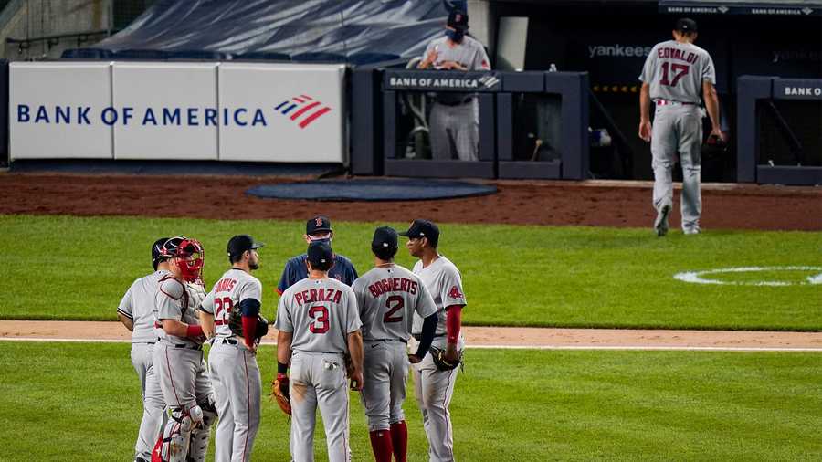 Boston Red Sox manager Ron Roenicke gathers the infield players as starting pitcher Nathan Eovaldi leaves during the sixth inning of a baseball game against the New York Yankees Saturday, Aug. 15, 2020, in New York. (AP Photo/Frank Franklin II)