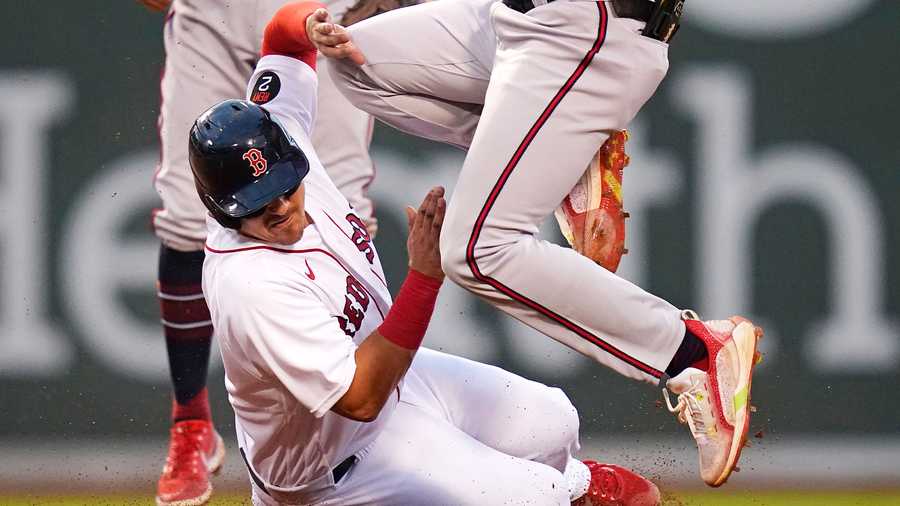 Boston Red Sox's Reese McGuire, left, collides with Atlanta Braves second baseman Vaughn Grissom while being forced out during the second inning of a baseball game Wednesday, Aug. 10, 2022, in Boston.