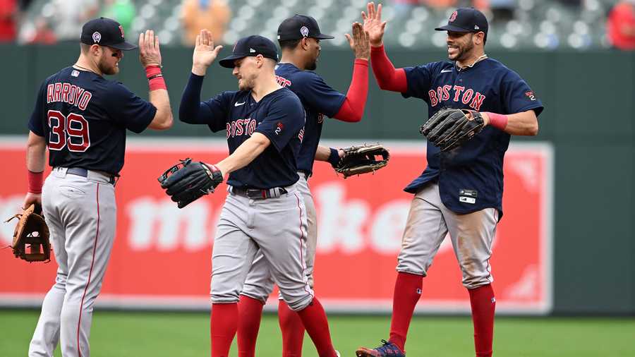 From left to right, Boston Red Sox's Christian Arroyo, Enrique Hernandez, Xander Bogaerts and Tommy Pham celebrate their win over the Baltimore Orioles in a baseball game, Sunday, Sept. 11, 2022, in Baltimore.