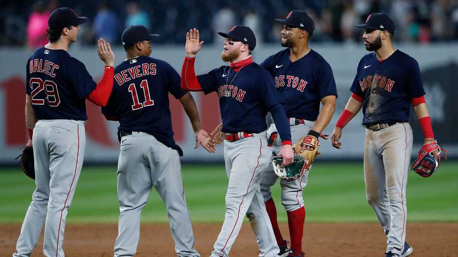 Boston Red Sox center fielder Alex Verdugo, center, celebrates with teammates after the Red Sox defeated the New York Yankees 7-3 in a baseball game Saturday, June 5, 2021, in New York. (AP Photo)