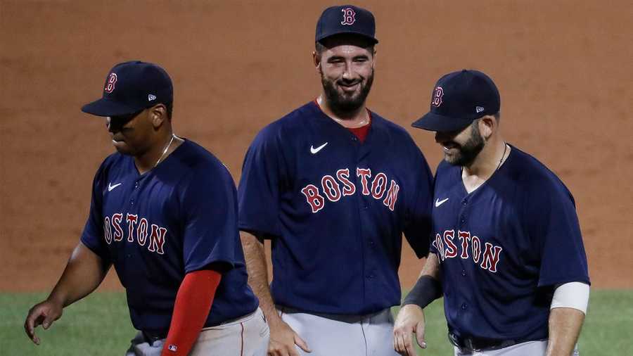 Boston Red Sox first baseman Mitch Moreland, right, celebrates with relief pitcher Brandon Workman, center, after the Red Sox defeated the New York Mets 6-5 in a baseball game Wednesday, July 29, 2020, in New York. (AP Photo/John Minchillo)