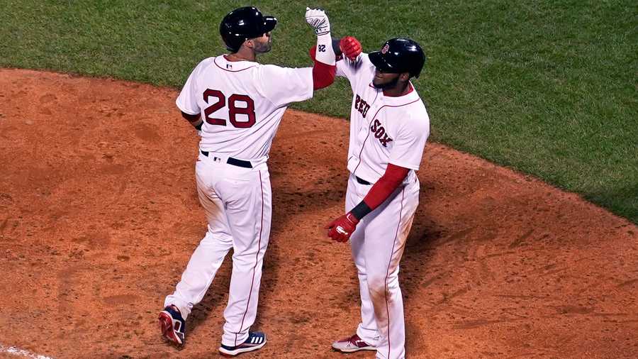 Boston Red Sox's J.D. Martinez (28) is congratulated by Franchy Cordero after his three-run home run in the eighth inning of a baseball game against the Tampa Bay Rays at Fenway Park, Monday, April 5, 2021, in Boston. (AP Photo)