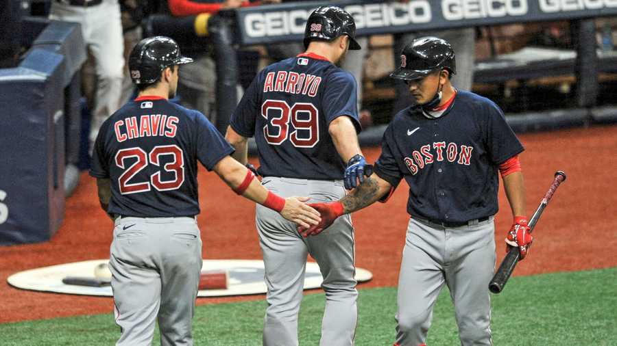 Boston Red Sox's Tzu-Wei Lin, right, congratulates Christian Arroyo (39) and Michael Chavis (23) after Arroyo's two-run home run off Tampa Bay Rays reliever Ryan Thompson during the sixth inning of a baseball game Sunday, Sept. 13, 2020, in St. Petersburg, Fla. (AP Photo/Steve Nesius)