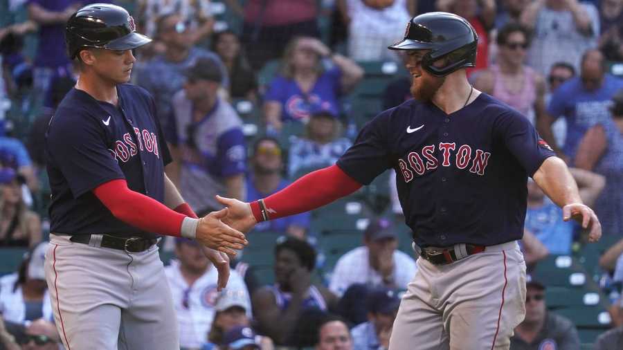 Boston Red Sox's Bobby Dalbec, left, celebrates with Christian Arroyo after scoring on a throwing error by Chicago Cubs relief pitcher Rowan Wick during the 11th inning of a baseball game in Chicago, Sunday, July 3, 2022.