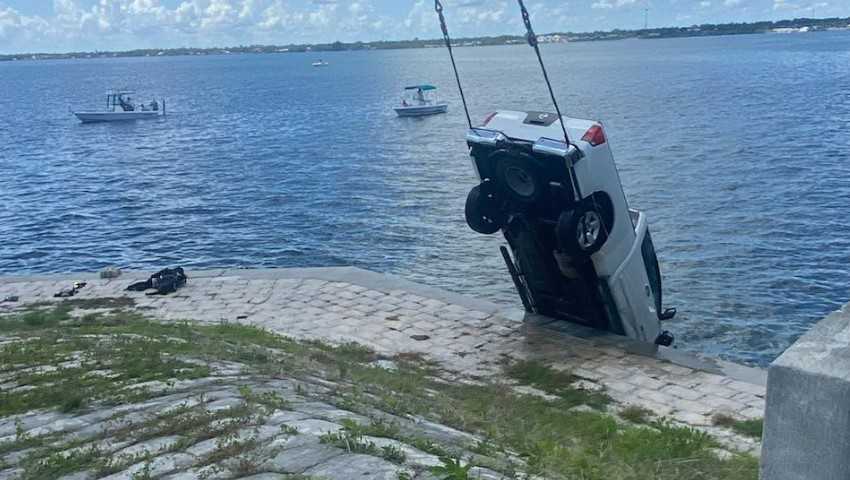 Passersby in Florida hold a driver's head above water after an accident