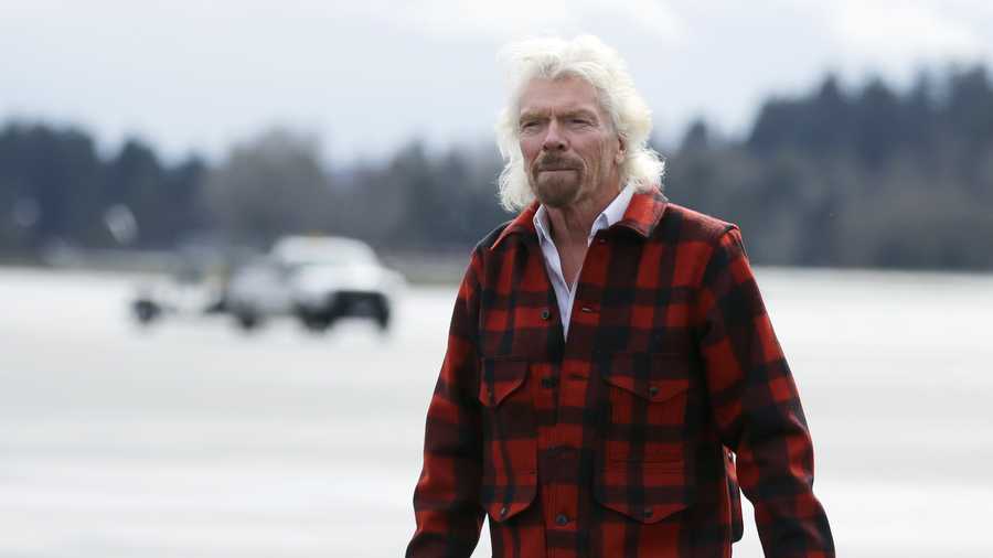 Sir Richard Branson, founder of Virgin Atlantic and the Virgin Group, walks on the tarmac after he arrived on a flight from London to Seattle, Monday, March 27, 2017, at Seattle-Tacoma International Airport in Seattle.
