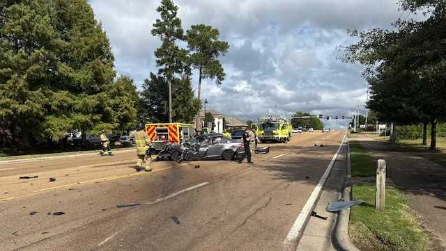 Crash involving school bus traps driver in car
