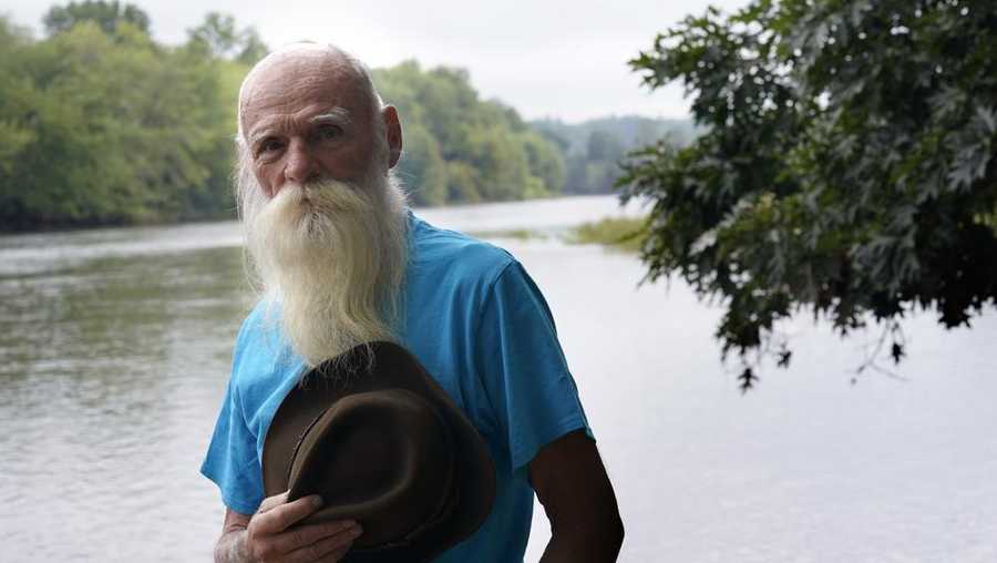 David Lidstone, 81, known to locals as "River Dave," stands for a photograph near the Merrimack River on Aug. 10, 2021, in Boscawen, N.H. Lidstone, a former hermit who a year ago was forced to leave his New Hampshire compound after two decades, has found a new home in Maine.
