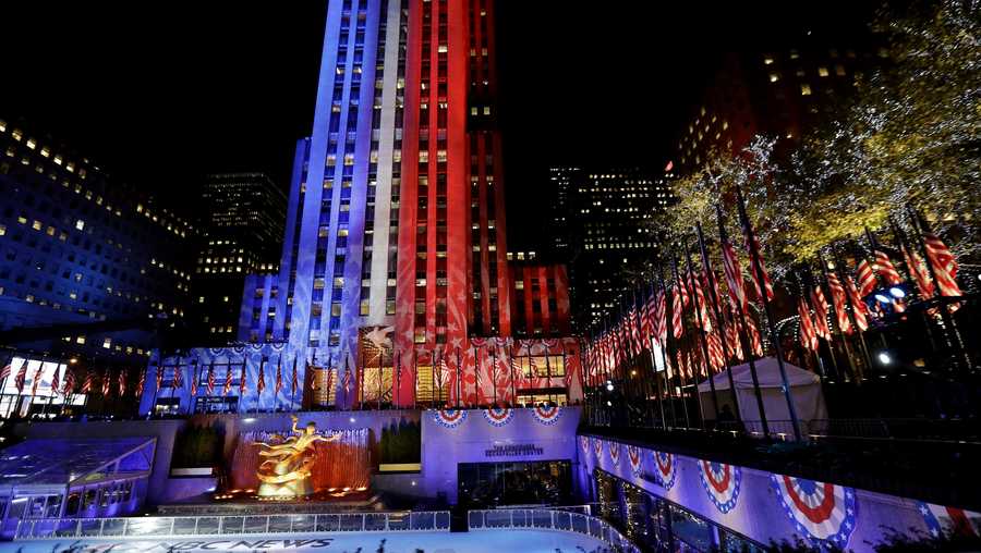 Patriotic lights illuminate Rockefeller Center during an Election Day gathering at the New York City landmark