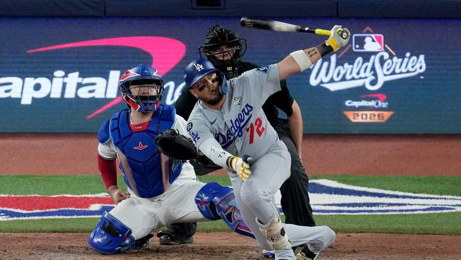 Los Angeles Dodgers&apos; Miguel Rojas follows through on a home run against the Toronto Blue Jays during the ninth inning in Game 7 of baseball&apos;s World Series, Saturday, Nov. 1, 2025, in Toronto.