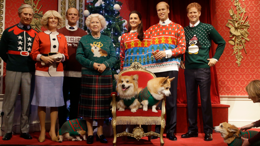 A dog owner tells her Pembrokeshire Welsh Corgi to 'stay' as four Corgi dogs pose next to wax work models of the British Royal family wearing colorful Christmas themed jumpers for a charity Christmas Jumper Day campaign at Madame Tussauds wax works in London, Tuesday, Dec. 6, 2016. The members of the royal family are from the left, Prince Charles Camilla, Duchess of Cornwall, Prince Phillip, Queen Elizabeth II, Kate, Duchess of Cambridge, Prince William, and Prince Harry.The Queen is well known for her love of this particular breed of dogs.