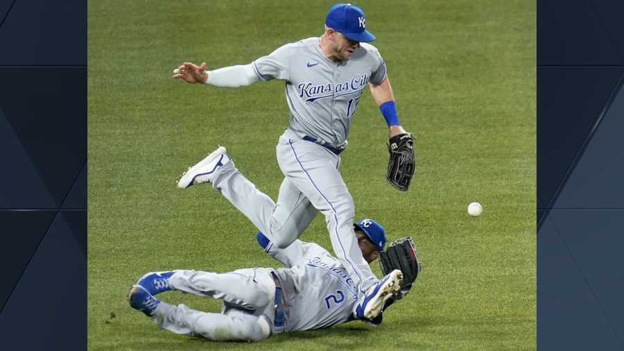 Kansas City Royals left fielder Hunter Dozier, top, and center fielder Michael A. Taylor can't come up with the fly ball by Pittsburgh Pirates pinch hitter Wilmer Difo that fell in four a hit to score Jacob Stallings in the seventh inning of a baseball game, Tuesday, April 27, 2021, in Pittsburgh. (AP Photo/Keith Srakocic)