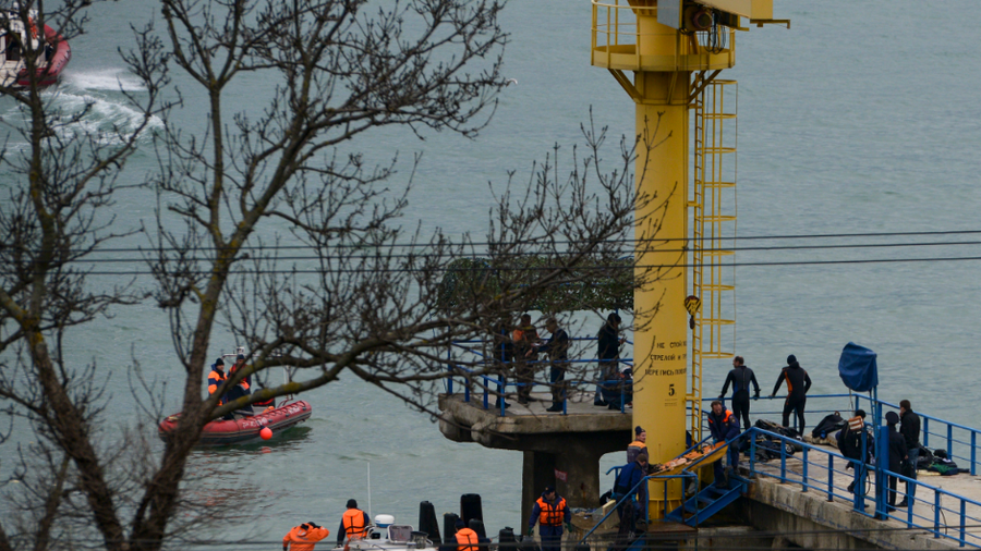 Russian rescue workers collect wreckage from the crashed plane at a pier just outside Sochi, Russia, Sunday, Dec. 25, 2016. Russian ships, helicopters and drones are searching for bodies after a plane carrying 93 people crashed into the Black Sea. The plane was taking the Alexandrov Ensemble, a military choir, to perform at Russia's air base in Syria when it went down shortly after takeoff. (AP Photo/Viktor Klyushin)