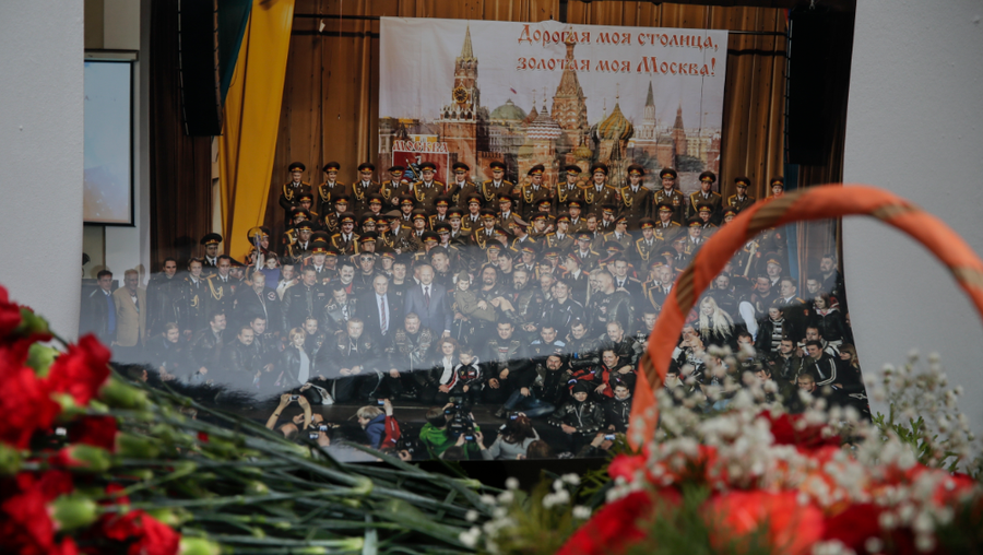 Flowers lay in front of a photo of a well-known military choir lays flowers at the military choir's building in Moscow, Russia, Sunday, Dec. 25, 2016, after a plane carrying 64 members of the Alexandrov Ensemble, crashed into the Black Sea minutes after taking off from the resort city of Sochi. The Russian plane was headed for an air base in Syria with 92 people aboard, Russia's Defense Ministry said. (AP Photo/Pavel Golovkin)