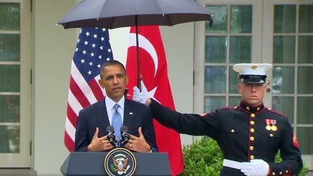 A Marine held an umbrella above then-President Barack Obama during a press conference with Recep Tayyip Erdogan, Turkey's prime minister, in 2013, as storm clouds unleashed a shower of rain.