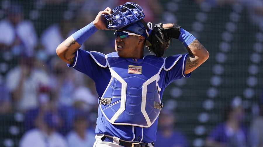 Kansas City Royals catcher Salvador Perez puts on his mask during the first inning of a spring baseball game against the Chicago Cubs in Mesa, Ariz., Tuesday, March 2, 2021. (AP Photo/Jae C. Hong)
