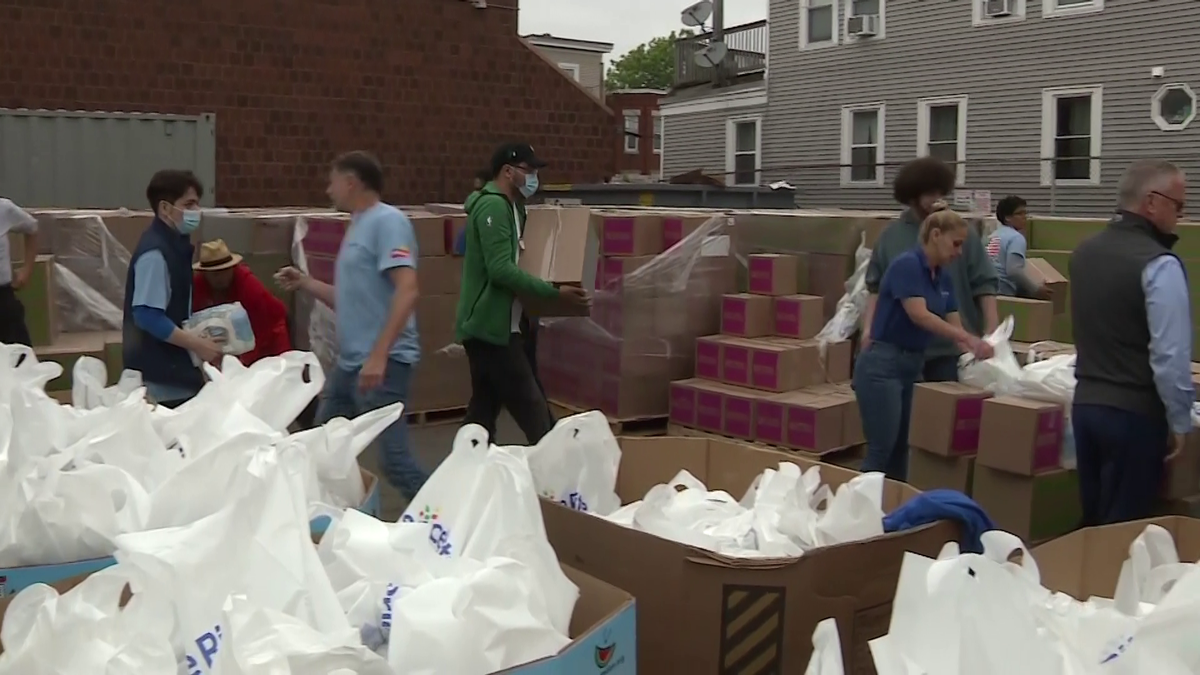 Hundreds of families in need given 25-pound packages of food, supplies