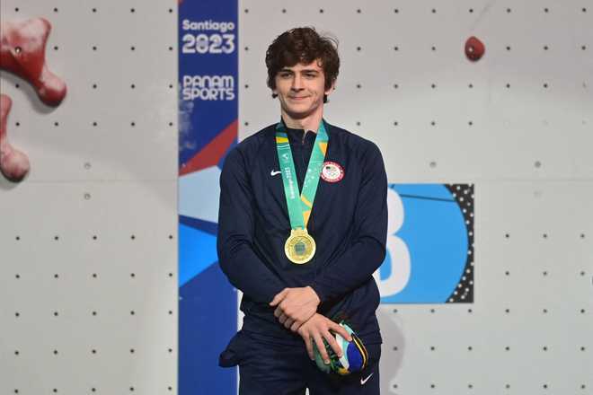 US&amp;apos&#x3B;&#x20;Samuel&#x20;Watson&#x20;poses&#x20;after&#x20;winning&#x20;the&#x20;gold&#x20;medal&#x20;during&#x20;the&#x20;podium&#x20;ceremony&#x20;of&#x20;the&#x20;men&amp;apos&#x3B;s&#x20;speed&#x20;final&#x20;climbing&#x20;event&#x20;during&#x20;the&#x20;Pan&#x20;American&#x20;Games&#x20;Santiago&#x20;2023,&#x20;at&#x20;the&#x20;Climbing&#x20;Walls&#x20;of&#x20;the&#x20;Cerrillos&#x20;Park&#x20;in&#x20;Santiago&#x20;on&#x20;October&#x20;22,&#x20;2023.&#x20;&#x28;Photo&#x20;by&#x20;Pablo&#x20;VERA&#x20;&#x2F;&#x20;AFP&#x29;&#x20;&#x28;Photo&#x20;by&#x20;PABLO&#x20;VERA&#x2F;AFP&#x20;via&#x20;Getty&#x20;Images&#x29;