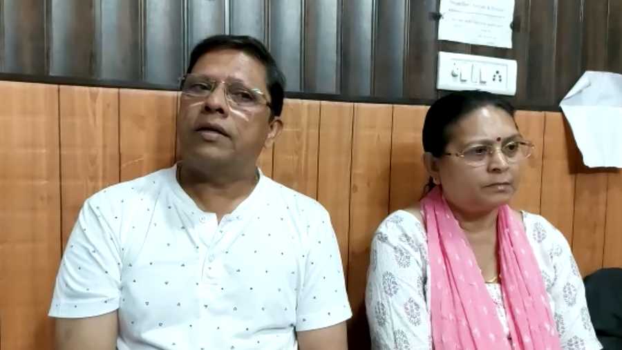 This image from video shows Sanjeev Ranjan Prasad, a 61-year-old retired government officer, and his wife Sadhana Prasad wait at a lawyer's chamber in Haridwar, India, Thursday, May 12, 2022. The Indian couple has sued their pilot son and daughter-in-law in a court demanding a grandchild within a year or compensation of 50 million rupees ($675,675).