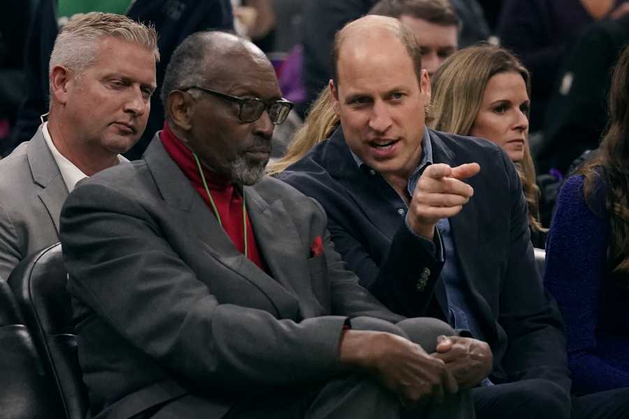 Britain's Prince William talks with former Boston Celtics player Satch Sanders during the second half of an NBA basketball game between the Celtics and the Miami Heat, Wednesday, Nov. 30, 2022, in Boston. (AP Photo/Charles Krupa)