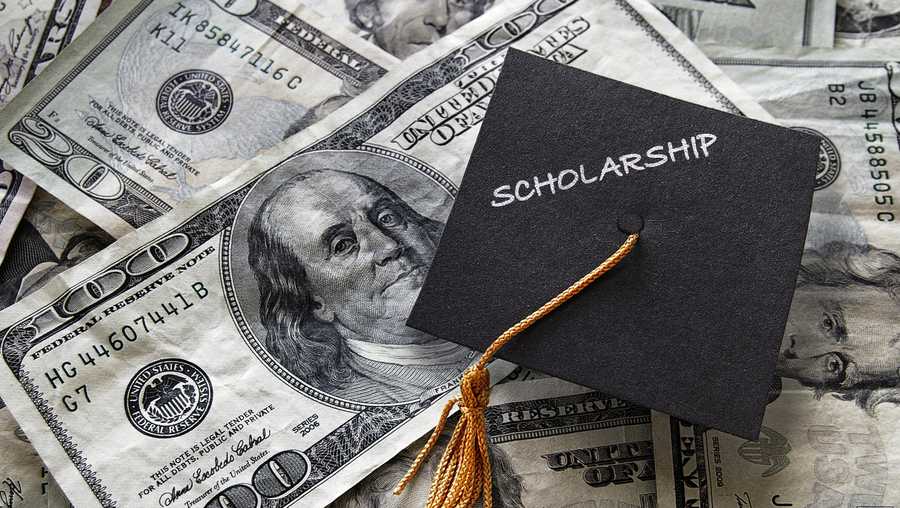 Scholarship mini graduation cap on  cash